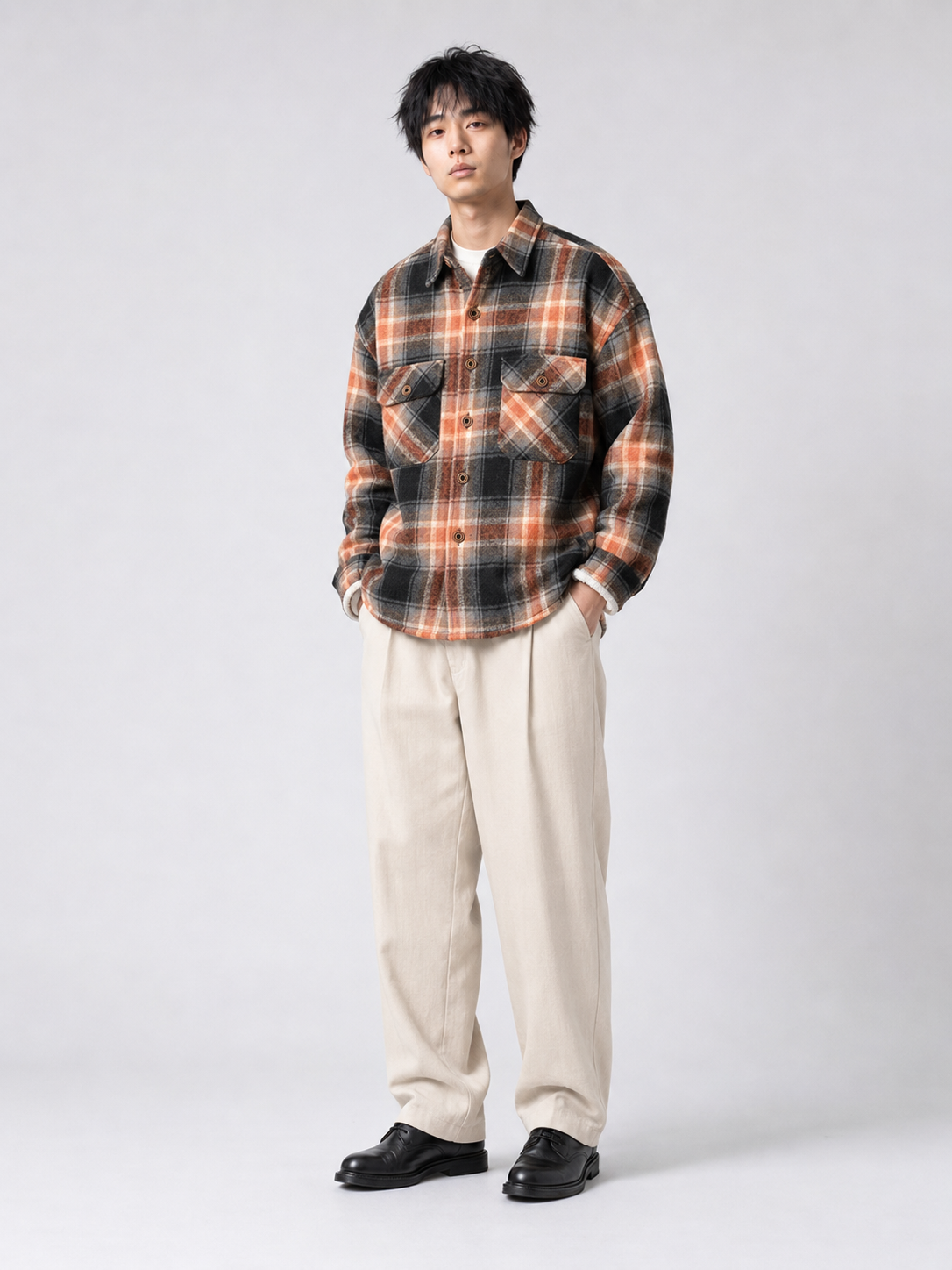 [color:black-orange-grid] Fleece-lined plaid shirt jacket in Black Orange Grid, model 1