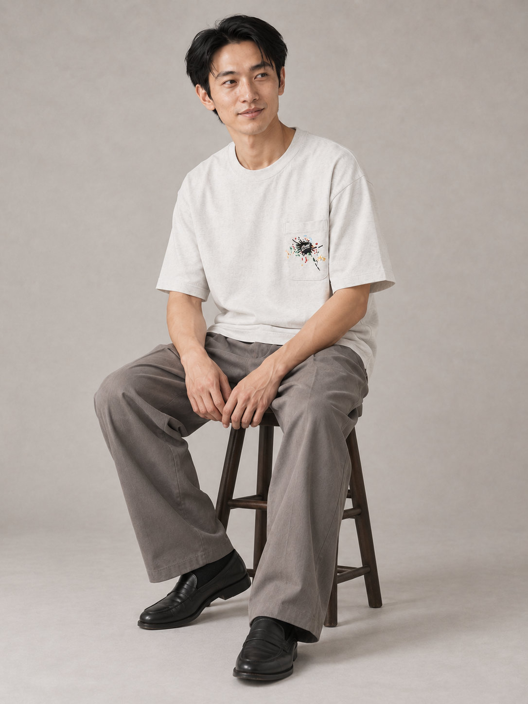[color:light-gray] Embroidered Pocket Tee — seated studio model view
