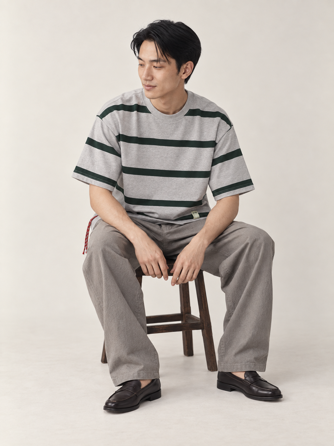 [color:light-gray] Striped Crewneck Tee — seated studio model