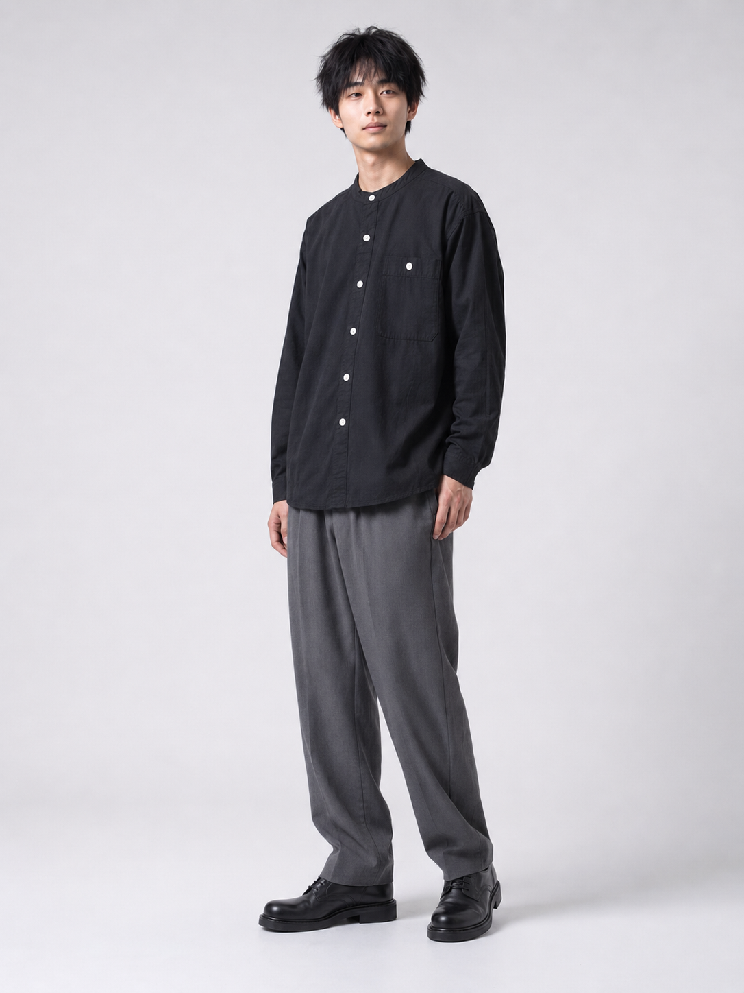 [color:black] Black Henry collar shirt on Japanese male model, three-quarter pose